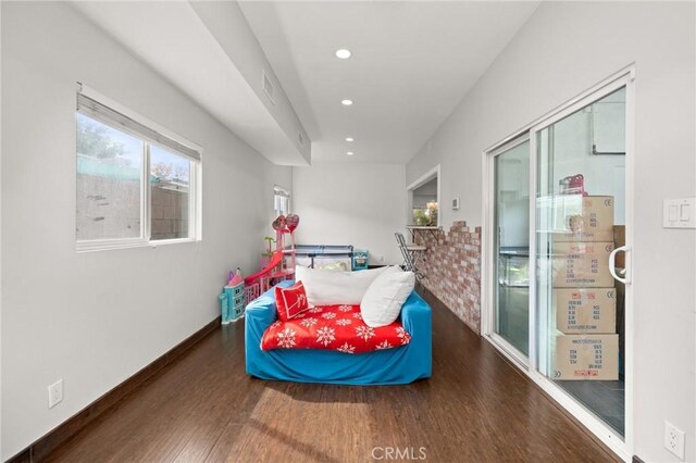 bedroom with dark hardwood / wood-style flooring