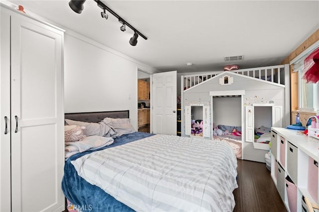 bedroom with visible vents and dark wood-style flooring