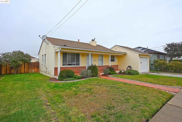 view of front of property with a garage and a front lawn