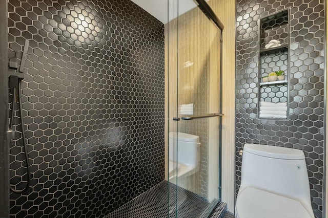 bathroom featuring tile walls, toilet, and tiled shower