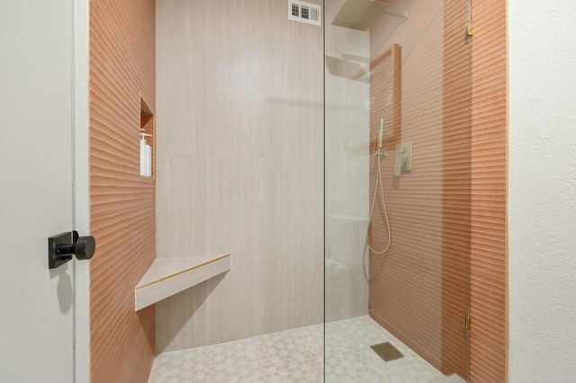 bathroom with tiled shower