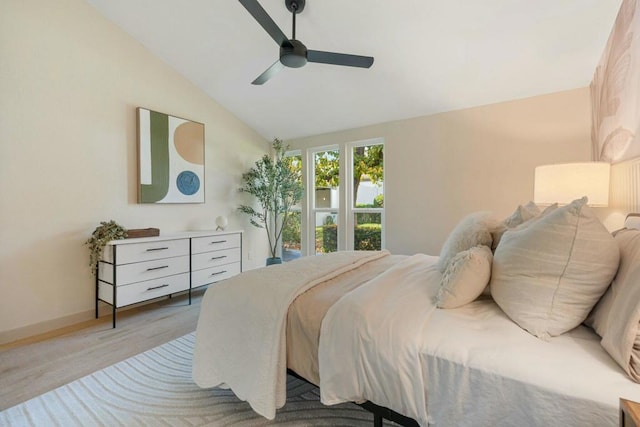 bedroom with vaulted ceiling, ceiling fan, and light hardwood / wood-style floors