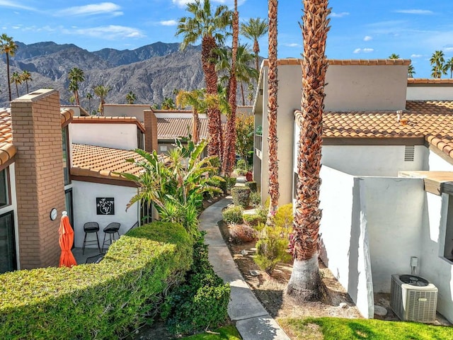 exterior space featuring central AC and a mountain view