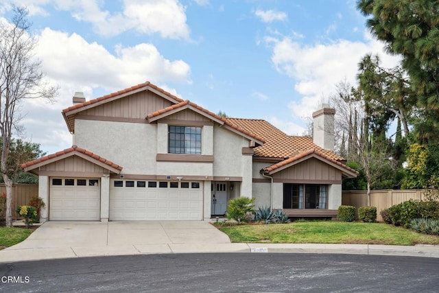 mediterranean / spanish home with concrete driveway, a chimney, a tiled roof, fence, and stucco siding