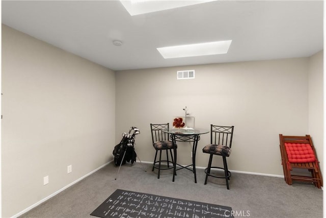 sitting room with carpet floors and a skylight