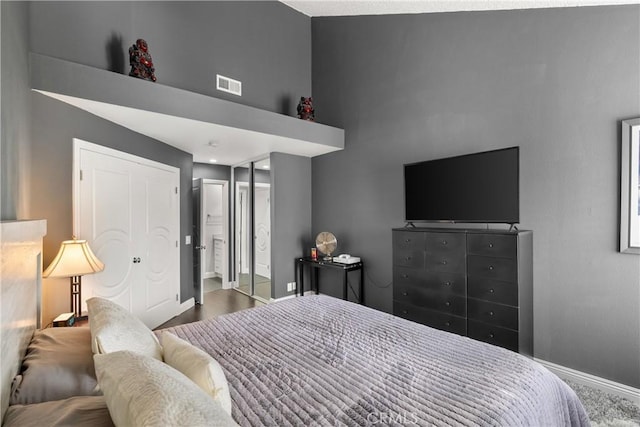 bedroom featuring a towering ceiling