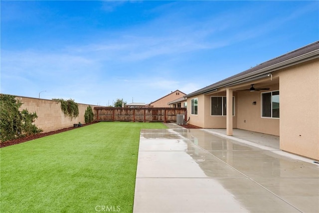 view of yard featuring ceiling fan, a patio, a fenced backyard, and central air condition unit