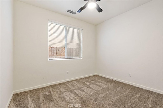 spare room with a ceiling fan, baseboards, visible vents, and carpet flooring