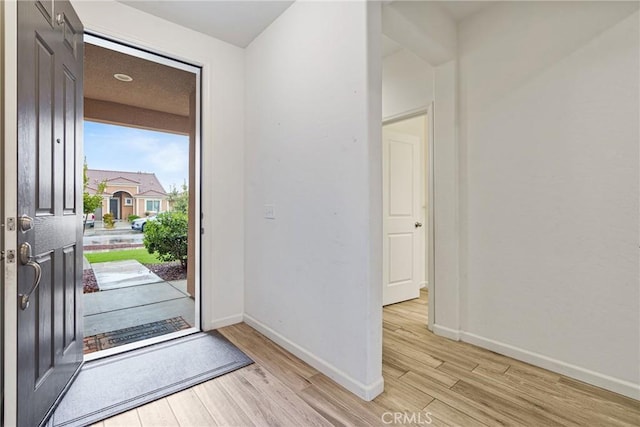 entryway featuring light wood-type flooring and baseboards