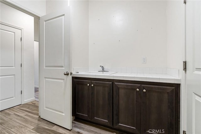 bathroom featuring wood finished floors and vanity