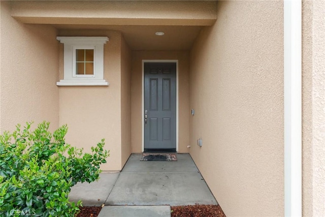 doorway to property with stucco siding