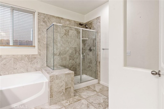 bathroom with a garden tub and a shower stall