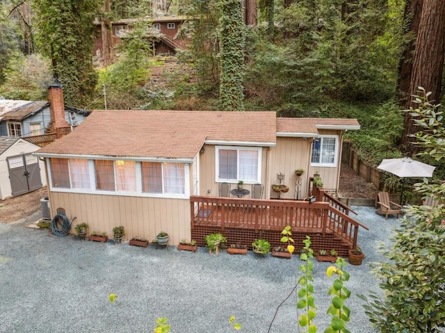 view of front of house with a deck and central air condition unit