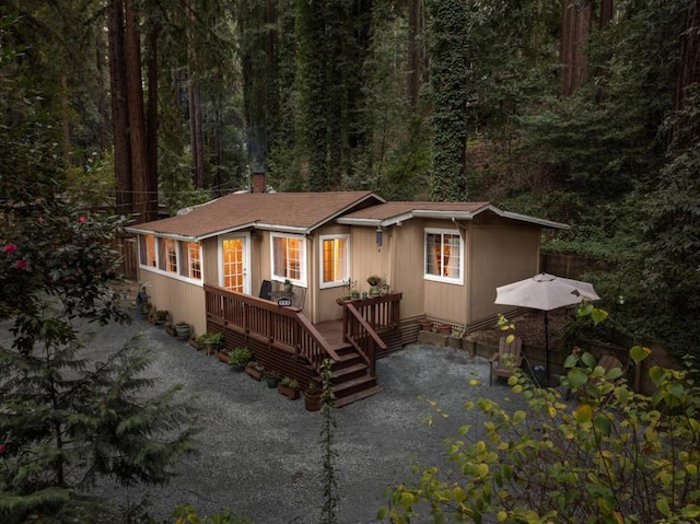 rear view of house featuring a deck