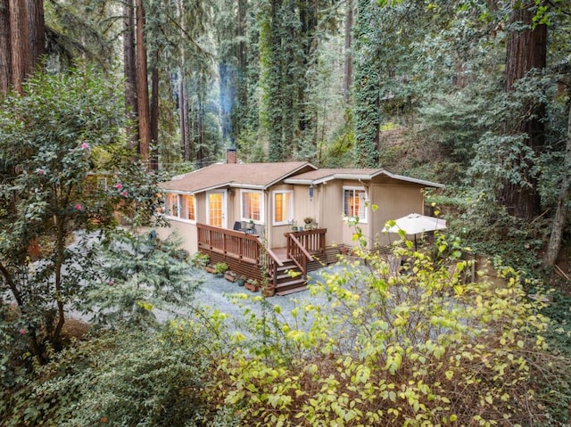 rear view of house featuring a deck