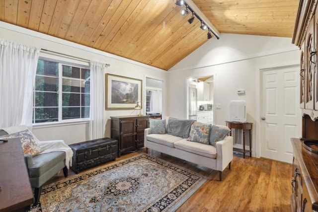 living room featuring wood ceiling, lofted ceiling, rail lighting, and light hardwood / wood-style floors