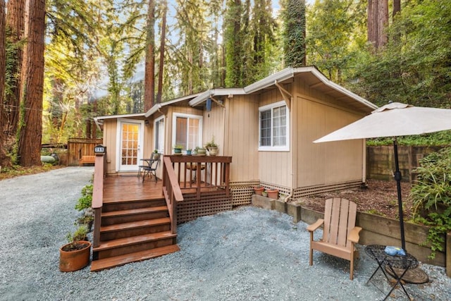 back of property with a wooden deck