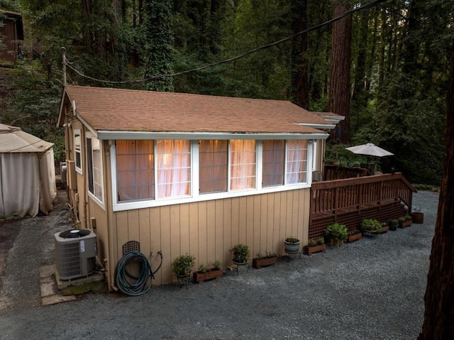 view of property exterior with central air condition unit and a deck