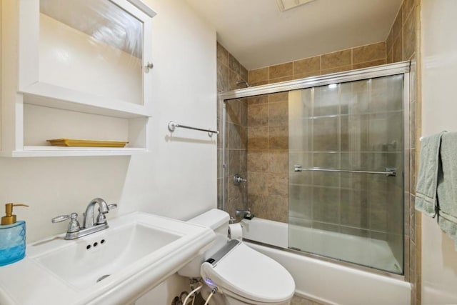 full bathroom with sink, enclosed tub / shower combo, and toilet