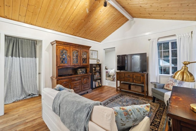 living room featuring vaulted ceiling with beams, light wood-type flooring, and wooden ceiling