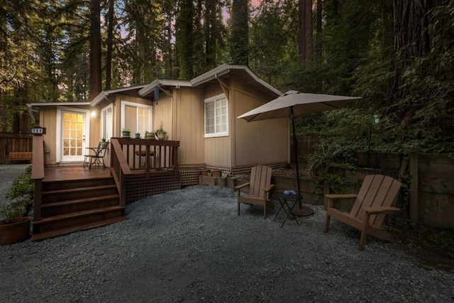 back of property with a wooden deck