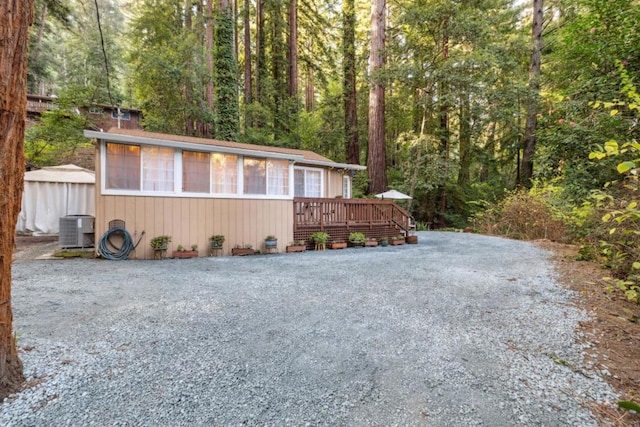 view of front of home featuring cooling unit and a deck