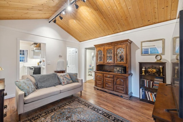 living room featuring wood ceiling, track lighting, lofted ceiling with beams, and light hardwood / wood-style flooring