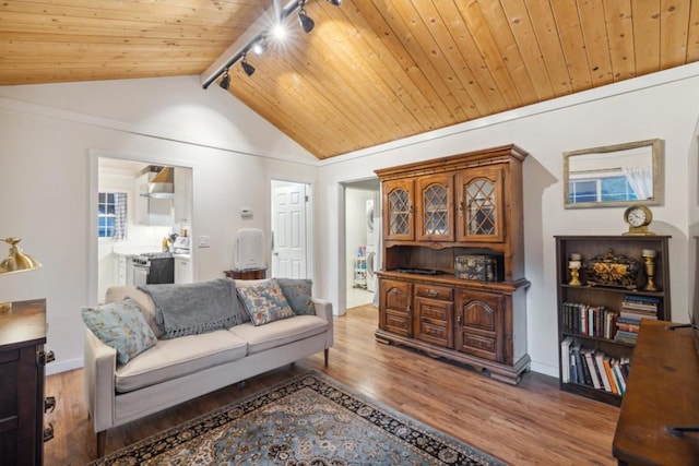 living room with vaulted ceiling, track lighting, wooden ceiling, and light wood-type flooring