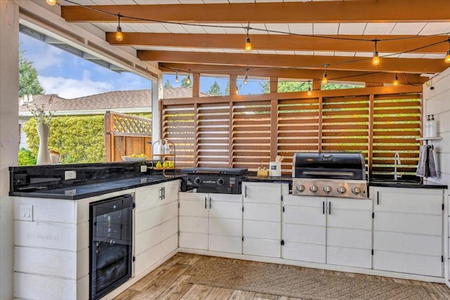 view of patio / terrace with area for grilling, sink, and wine cooler