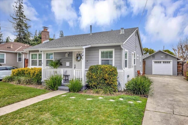 view of front of property with an outbuilding, a garage, a front lawn, and covered porch