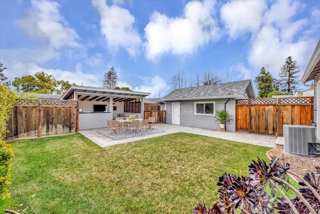 rear view of house featuring an outdoor structure, central AC unit, a patio, and a lawn