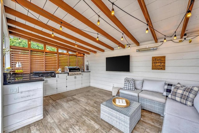 interior space with hardwood / wood-style floors, lofted ceiling with beams, and rail lighting