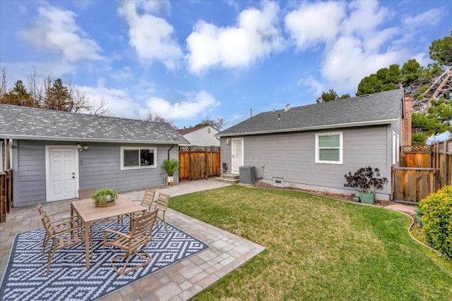 rear view of house with a yard, central AC, and a patio area