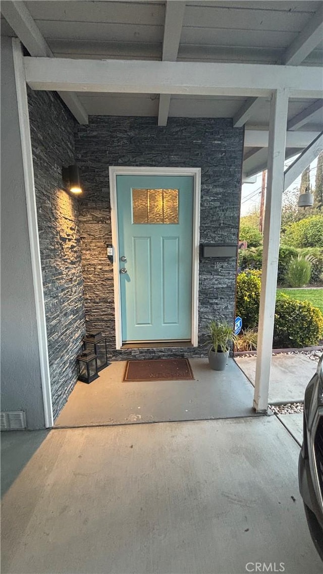 doorway to property with a patio