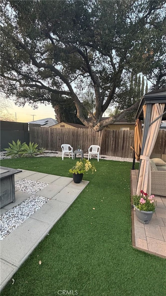 yard at dusk with a patio