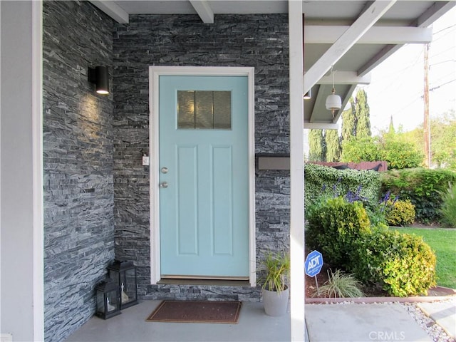 view of exterior entry with stone siding