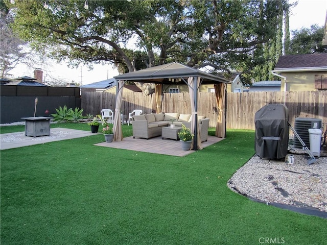 view of yard with a fenced backyard, an outdoor living space, cooling unit, and a gazebo