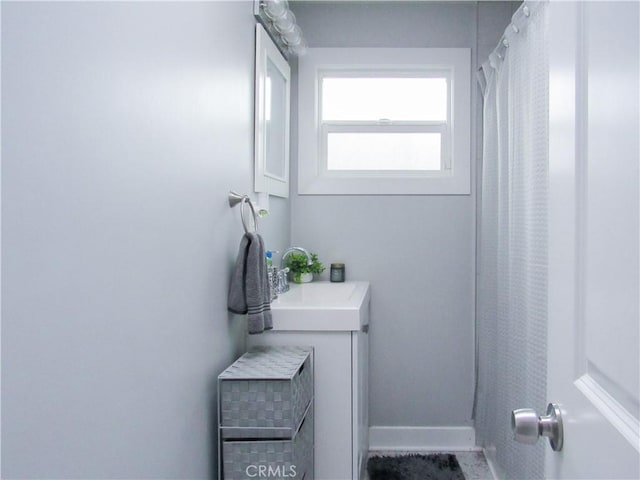 bathroom with baseboards and a sink