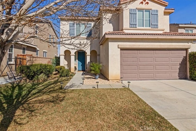 mediterranean / spanish-style home with a garage and a front lawn