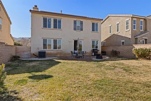 back of house with a patio, a yard, and central air condition unit