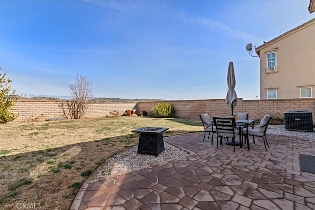 view of patio featuring cooling unit and an outdoor fire pit