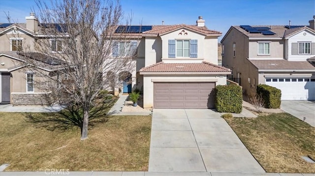 view of front of house with a garage, a front yard, and solar panels