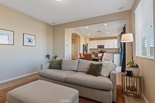 living room featuring hardwood / wood-style flooring and sink