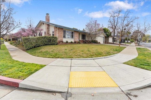 view of front of home featuring a garage and a front yard