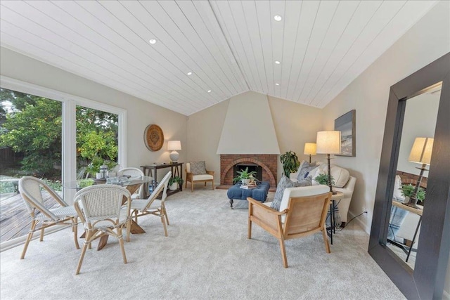 living room featuring lofted ceiling, wood ceiling, light colored carpet, and a large fireplace