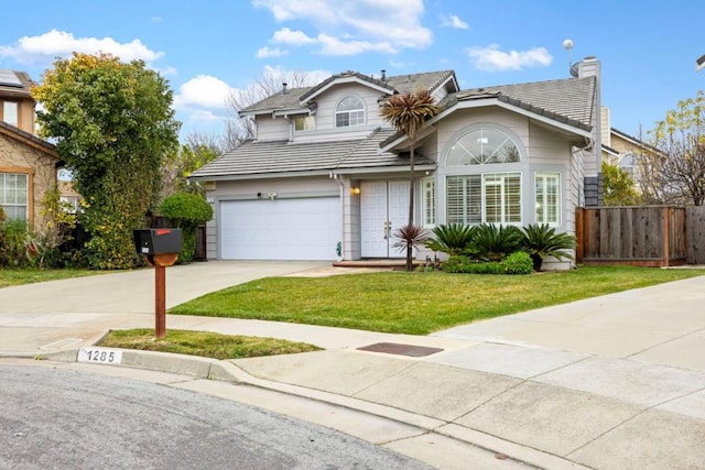 view of property featuring a garage and a front yard