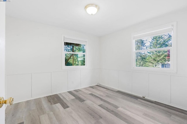 unfurnished room with light hardwood / wood-style flooring