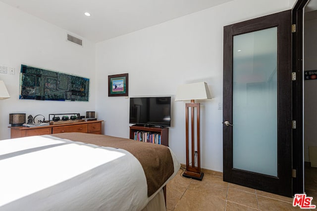 bedroom featuring light tile patterned floors