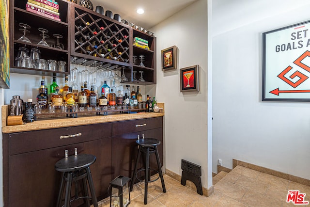 bar with dark brown cabinetry