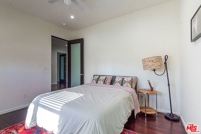 bedroom with dark hardwood / wood-style floors and ceiling fan